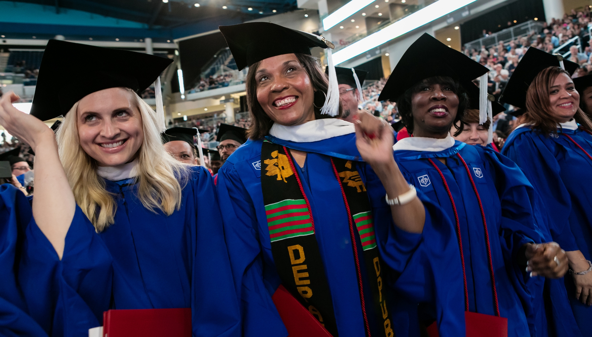 Students are all smiles after flipping their tassels at the end of the College of Liberal Arts and Social Sciences and the School for New Learning ceremony in Wintrust Arena. Approximately 6,700 students graduated during five ceremonies held over the weekend in Chicago. (DePaul University/Jeff Carrion)